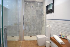 a bathroom with a shower and a toilet and a sink at Desconectate in Aldán