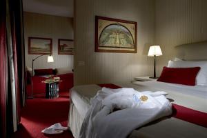 Postel nebo postele na pokoji v ubytování Hotel dei Borgognoni