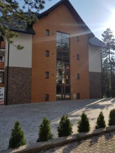 a large brick building with a large window at Apartmani F&A in Zlatibor