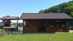 a gazebo with a roof on the grass at RosenVille in Râşnov