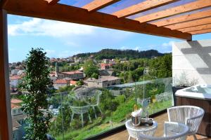 a balcony with a view of a city at Desconectate in Aldán