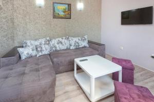 a living room with a couch and a table at Family Hotel Argo in Varna City