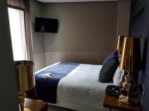 Cama ou camas em um quarto em Hotel Art Santander