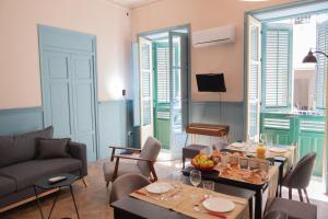 a living room with a couch and a table with food on it at Al teatro Massimo in Palermo