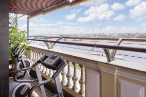 a balcony with a treadmill and a view of the water at LCS Hotel & Apartment in Phnom Penh