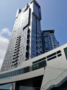 a tall white building with a lot of windows at Sea Towers Apartment in Gdynia