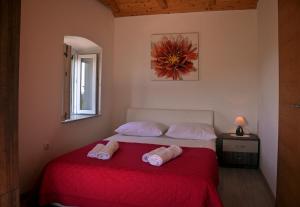 a bedroom with a bed with two towels on it at Mediterranean stone house in Babino Polje