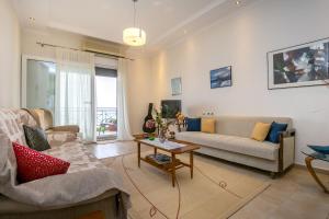 a living room with a couch and a table at Kallisti Apartment in Skala Kallirakhis