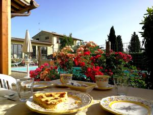 a table with plates of food on it with flowers at Country House Nonna Rana in Cannara