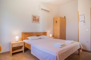 a bedroom with a bed with two towels on it at Apartments Dandić in Orlec