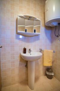 a bathroom with a sink and a mirror at Apartments Dandić in Orlec