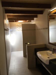 a bathroom with a sink and a mirror at Shanze Bora villa in Liugui