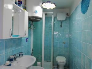 a bathroom with a sink and a toilet and a shower at La Conchiglia Vietrese in Vietri sul Mare