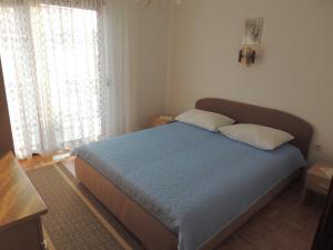 a bedroom with a bed with two pillows on it at Tomić in Novi Vinodolski