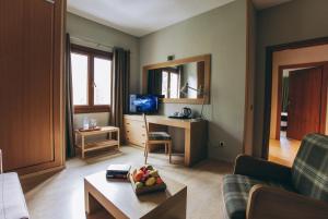 a living room filled with furniture and a window at Hotel Manantial in Caldes de Boi