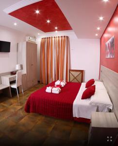 a bedroom with a large bed with a red blanket at Policlinico Happy Home in Messina