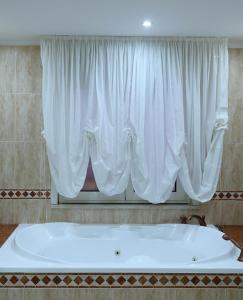 a large bath tub in front of a window at Policlinico Happy Home in Messina