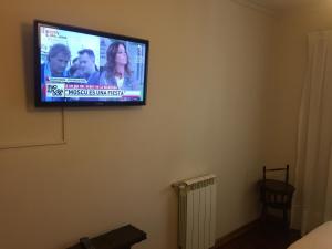 a flat screen tv hanging on a wall at Departamentos de Buen Nivel in Mendoza