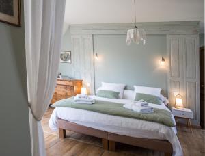 a bedroom with a bed with towels on it at La Maison du Carroir in Blois