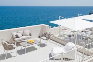 a balcony with chairs and a table on a yacht at Dimora Talenti in Polignano a Mare