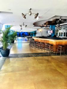 a bar with chairs and a counter in a room at Apartment at De Soleil Hotel on Ocean Drive in Miami Beach