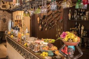 a bar with a buffet of food in a room at Pousada Hospedaria da Villa in Tiradentes +62 photos