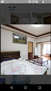 a bedroom with a bed and a room with a table at Business Hotel Seifusou in Saiki