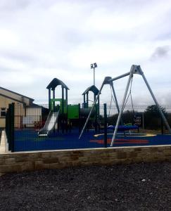 a playground with three slides on a blue at Leghowney House in Donegal