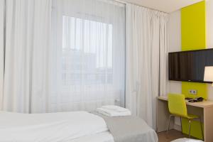 Postel nebo postele na pokoji v ubytování MediInn Hotel Oslo