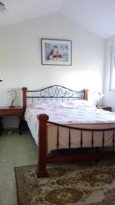 uma cama num quarto com uma fotografia na parede em Guest house Duletic em Budva