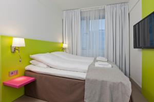 Postel nebo postele na pokoji v ubytování MediInn Hotel Oslo