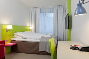 Postel nebo postele na pokoji v ubytování MediInn Hotel Oslo