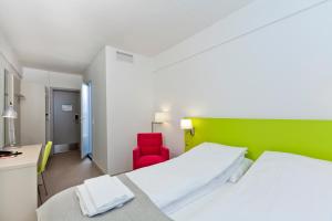 Postel nebo postele na pokoji v ubytování MediInn Hotel Oslo