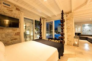 a bedroom with a bed and a large window at Villa Pela in Aliki
