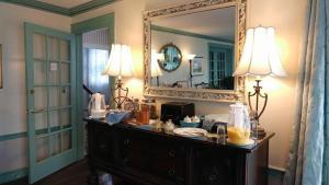 a room with a mirror and a dresser with food on it at Harborview Inn in Gloucester