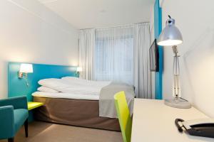 Postel nebo postele na pokoji v ubytování MediInn Hotel Oslo