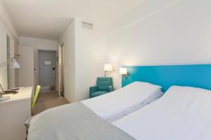 Postel nebo postele na pokoji v ubytování MediInn Hotel Oslo