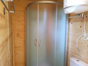 a shower in a bathroom with wooden walls at Ku kū in Šventoji +66 photos