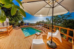 a deck with an umbrella and a swimming pool at Villa Cosimo in Cefalù