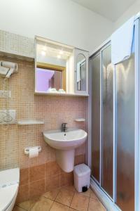 a bathroom with a sink and a shower at Hotel Rubens in Rimini
