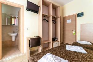 a hotel room with two beds and a bathroom at Hotel Rubens in Rimini