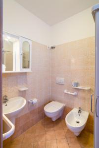 a bathroom with a toilet and a sink at Hotel Rubens in Rimini