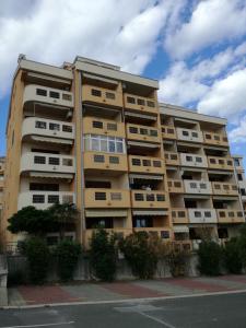 a tall apartment building with balconies on a street at Apartman Una in Crikvenica