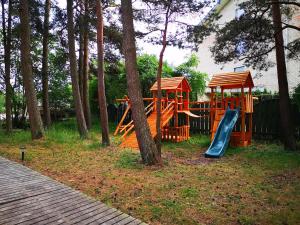 a playground with a slide and a gazebo at Ku kū in Šventoji