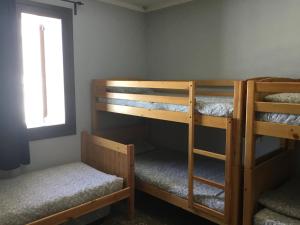 two bunk beds in a room with a window at Xalet-Refugi U.E.C. in La Molina