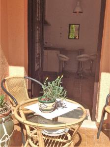 a table and chairs with a potted plant on it at Apartment Ute in Mali Lošinj