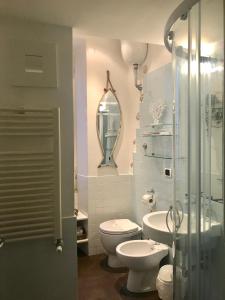een badkamer met een toilet, een wastafel en een spiegel bij Trastevere Star in Rome