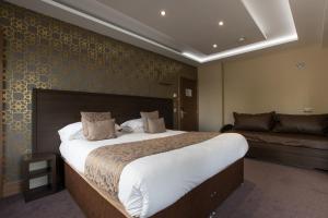 a bedroom with a large bed and a large window at Grainger Apartments in Newcastle upon Tyne