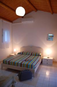 Tempat tidur dalam kamar di Vecchia Fattoria Case Vacanza al mare