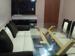 a living room with a glass table and a couch at Къща за гости Краси in Krapets